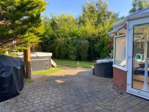 a backyard with a house and a driveway at Beautiful 3 Bedroom Detached home with hot tub in Fisherrow