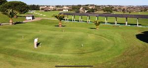a man is playing golf on a golf course at Kiko Las Americas in Isla Cristina