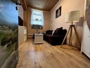 a living room with a couch and a window at Entspannung in Hellenthal in Hellenthal