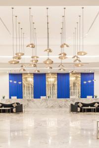 a rendering of a lobby with blue walls and chandeliers at Pickalbatros Blu Spa Resort - Adults Friendly 16 Years Plus- Ultra All-Inclusive in Hurghada