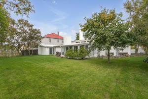 a white house with a yard in front of it at Luxurious Private Villa in Reykjavík