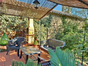 a patio with two chairs and a table at Casa Le Celle in Cortona