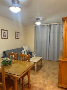 a living room with a table and a couch at Apartamento portil in El Portil