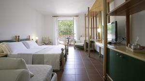 a bedroom with a bed and a television and a couch at Residenza Sant’Anna Del Volterraio in Portoferraio