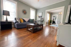 a living room with a couch and a table at Historic Revival 2BR Midtown Memphis Fast Wifi Free Parking Yes Pets in Memphis
