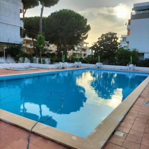 a large swimming pool with blue water at Nic holiday house in Santa Marinella