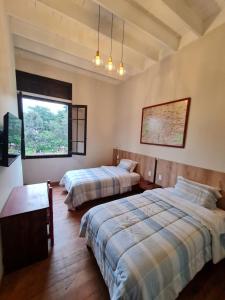 a bedroom with two beds and a window at Flying Dog Lima B&B in Lima