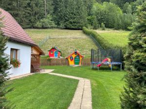 a yard with a picnic table and a playground at Apartments Ve dvoře in Velké Karlovice