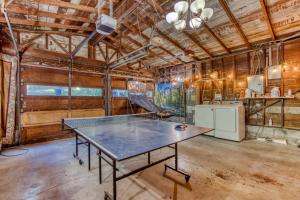 a ping pong table in a room with a kitchen at Sasquatch and Bigfoot in Portland