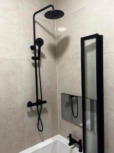 a bathroom with a shower with a mirror and a sink at Spire Accommodations Ltd in Bradford