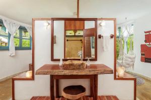 a bathroom with a sink and a mirror at Dos Ceibas Tulum Feel Good Hotel in Tulum