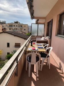 a small balcony with a table and chairs on it at Lugano Viganello in Lugano