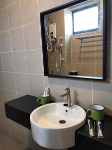 a bathroom with a sink and a mirror at New 2 storey-Majestic Homestay 3 min to Night Market in Brinchang