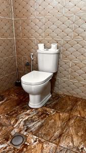 a bathroom with a white toilet in a room at Bedouin host camp& with tour in Wadi Rum