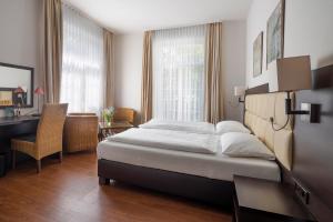 Postel nebo postele na pokoji v ubytování Hotel Minerva