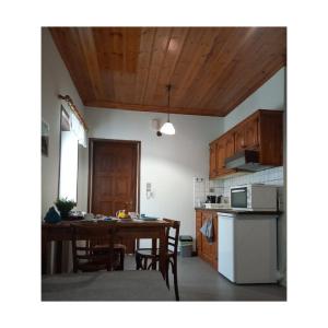 a kitchen and dining room with a table and chairs at Potamolithos Suites in Konitsa