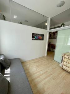 a living room with a couch and a wooden floor at Claudia's Home in FieraCity&MiCo&SanSiro in Milan