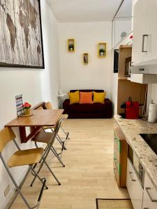 a kitchen and living room with a table and a couch at Claudia's Home in FieraCity&MiCo&SanSiro in Milan