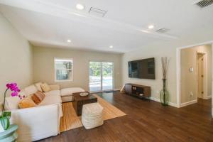 a living room with a white couch and a table at Luxury home in the heart of South Tampa & POOL! in Tampa
