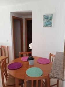 drewniany stół z czterema matami w obiekcie Apartamento de 2 dormitorios en Magic World, Marina D'or w mieście Oropesa del Mar