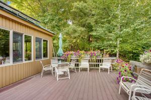 a deck with chairs and a table and umbrella at Sugar Run: 25 in Sugarbush Village