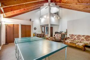 a ping pong table in the middle of a living room at Sugar Run: 25 in Sugarbush Village