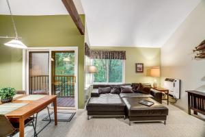 a living room with a couch and a table at Sugar Run: 25 in Sugarbush Village
