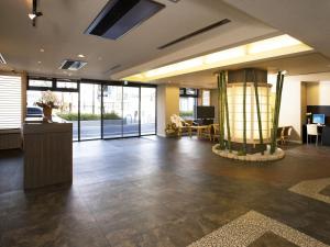 an office lobby with a large room with a fireplace at Kyoto Ryokan Hirashin in Kyoto