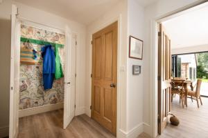 a hallway with a door and a dining room at Partridge Lodge in Northallerton
