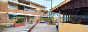 a building with benches and plants in front of it at Matinhos 150 metros da praia in Matinhos