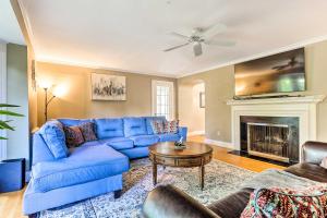 a living room with a blue couch and a fireplace at Grand Worcester Getaway with Large Private Yard! in Worcester