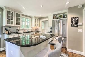 a kitchen with a glass counter top and a refrigerator at Grand Worcester Getaway with Large Private Yard! in Worcester