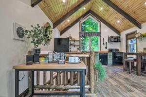 a kitchen with a wooden table in a room at Pet-Friendly Delta Cabin with Private Hot Tub! in Delta