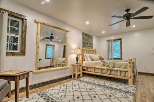 a bedroom with a bed and a mirror at Pet-Friendly Delta Cabin with Private Hot Tub! in Delta