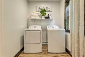 a kitchen with two white appliances in a room at Pet-Friendly Delta Cabin with Private Hot Tub! in Delta