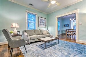 a living room with a couch and a table at Colorful Cottage with Deck about 5 Mi to Downtown! in Little Rock