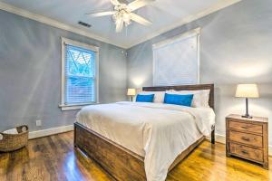 a bedroom with a bed and a ceiling fan at Colorful Cottage with Deck about 5 Mi to Downtown! in Little Rock