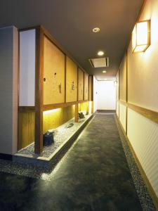 a hallway of a building with a long corridor at Kyoto Ryokan Hirashin in Kyoto