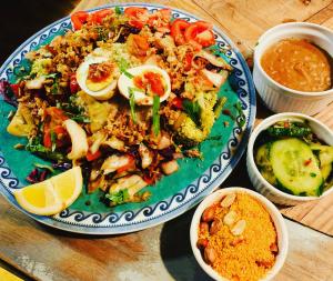 a plate of food with rice and vegetables on a table at Eco-Camping De Helleborus, Yurt, Bell & Safari tent, Pipo, Caravans, Dorms and Units in Groningen