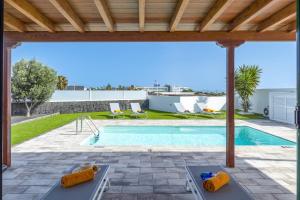 a swimming pool in a villa with a view at Villa Arena by Villa Plus in Playa Blanca