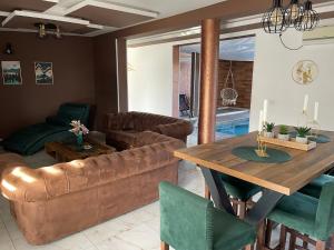 a living room with a couch and a table at Vila Sky Kragujevac in Kragujevac
