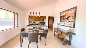 a dining room with a glass table and chairs at San Angel Villas in San Antonio