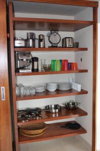 a shelf filled with dishes and pots and pans at San Angel Villas in San Antonio