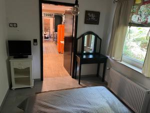 a bedroom with a bed and a mirror and a hallway at Haus am See (Teich) 