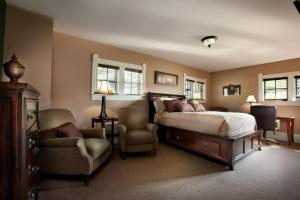 a bedroom with a bed and a chair and a couch at Grant Street Inn - Bloomington in Bloomington