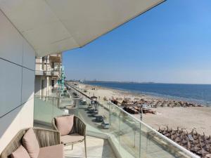 a view of the beach from the balcony of a building at APARTAMENT De LUX ZEV MEDITERANEO in Mamaia Nord