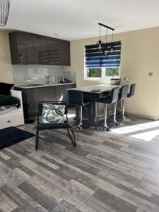 a kitchen and living room with a table and chairs at Luxury stay Kings Annexe 5 minutes from Longleat in Warminster