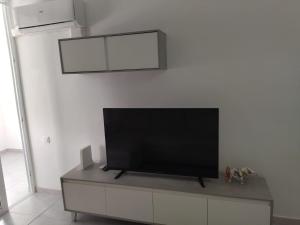 a flat screen tv sitting on top of a cabinet at Playa del Inglés 5 min walk from Yumbo! 304 in Maspalomas