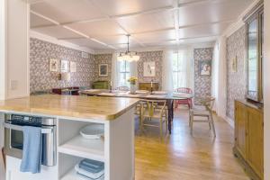a kitchen and dining room with a table and chairs at The School House - Walk to all Shops and Restaurants - New Remodel in Manchester