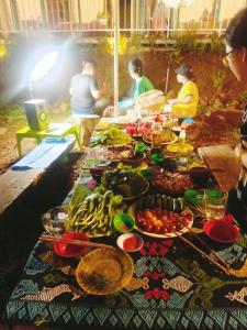 a table with a bunch of food on it at Paradiso Homestay Mangden in Kon Von Kla